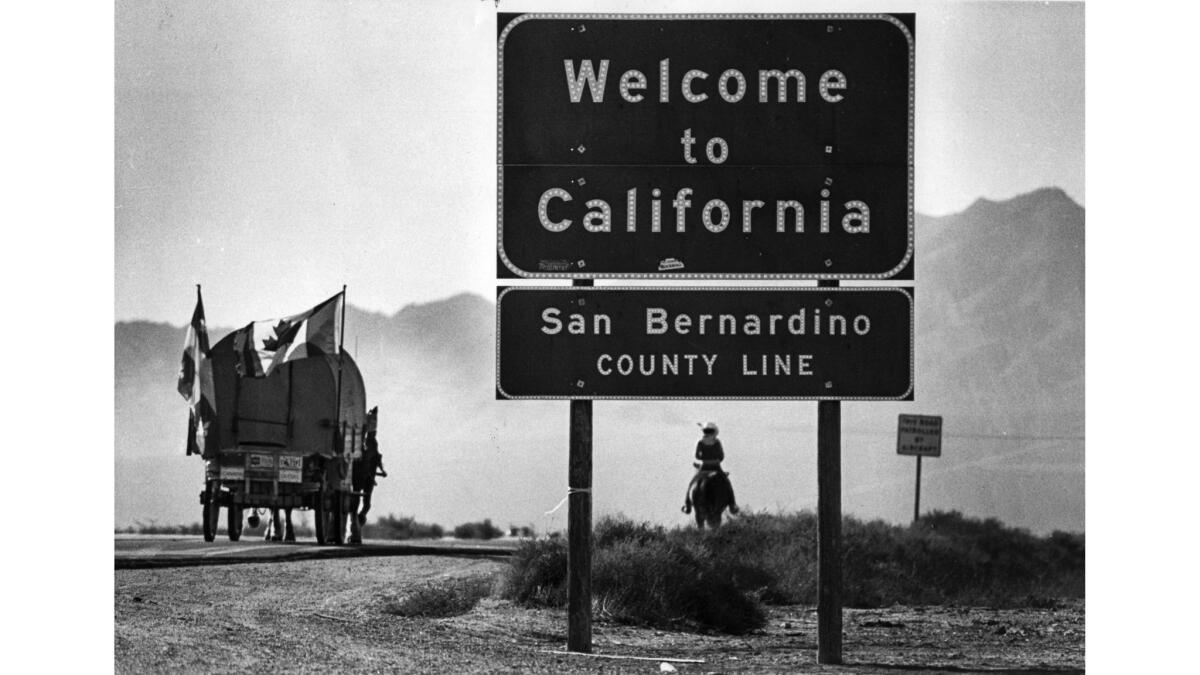 Nov. 30, 1982: A covered wagon crosses into California on Interstate 15. Marcel and Huguette Roberts spent 18 months traveling from Montreal, Canada, to Los Angeles.