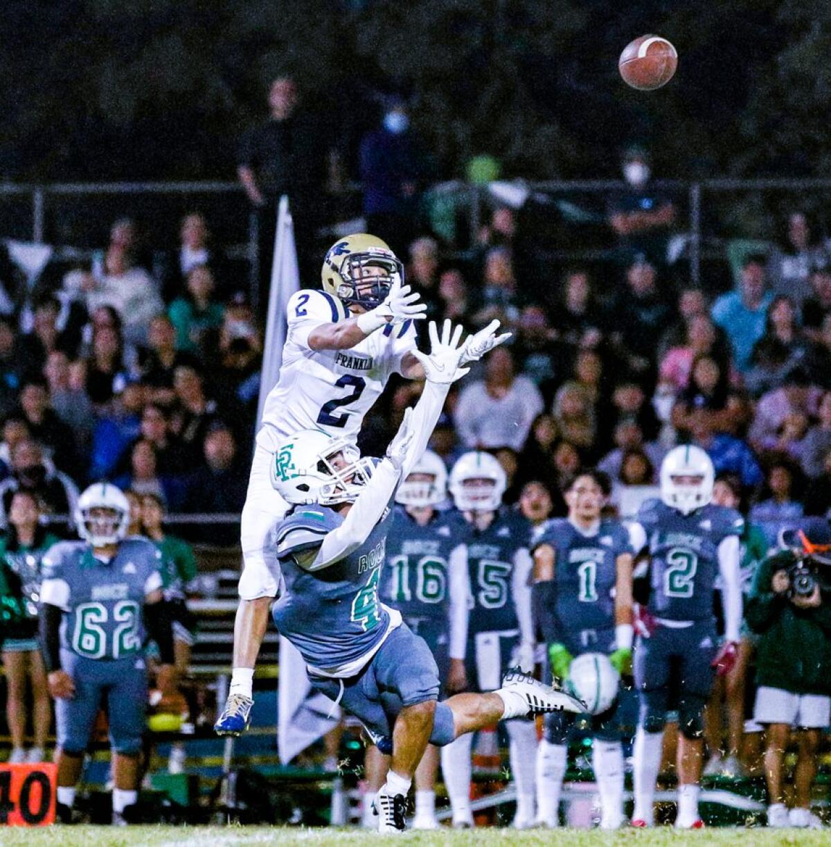 Hector Ceballos of Franklin leaps over Anthony Leon-Vidales of Eagle Rock to make 42-yard catch.