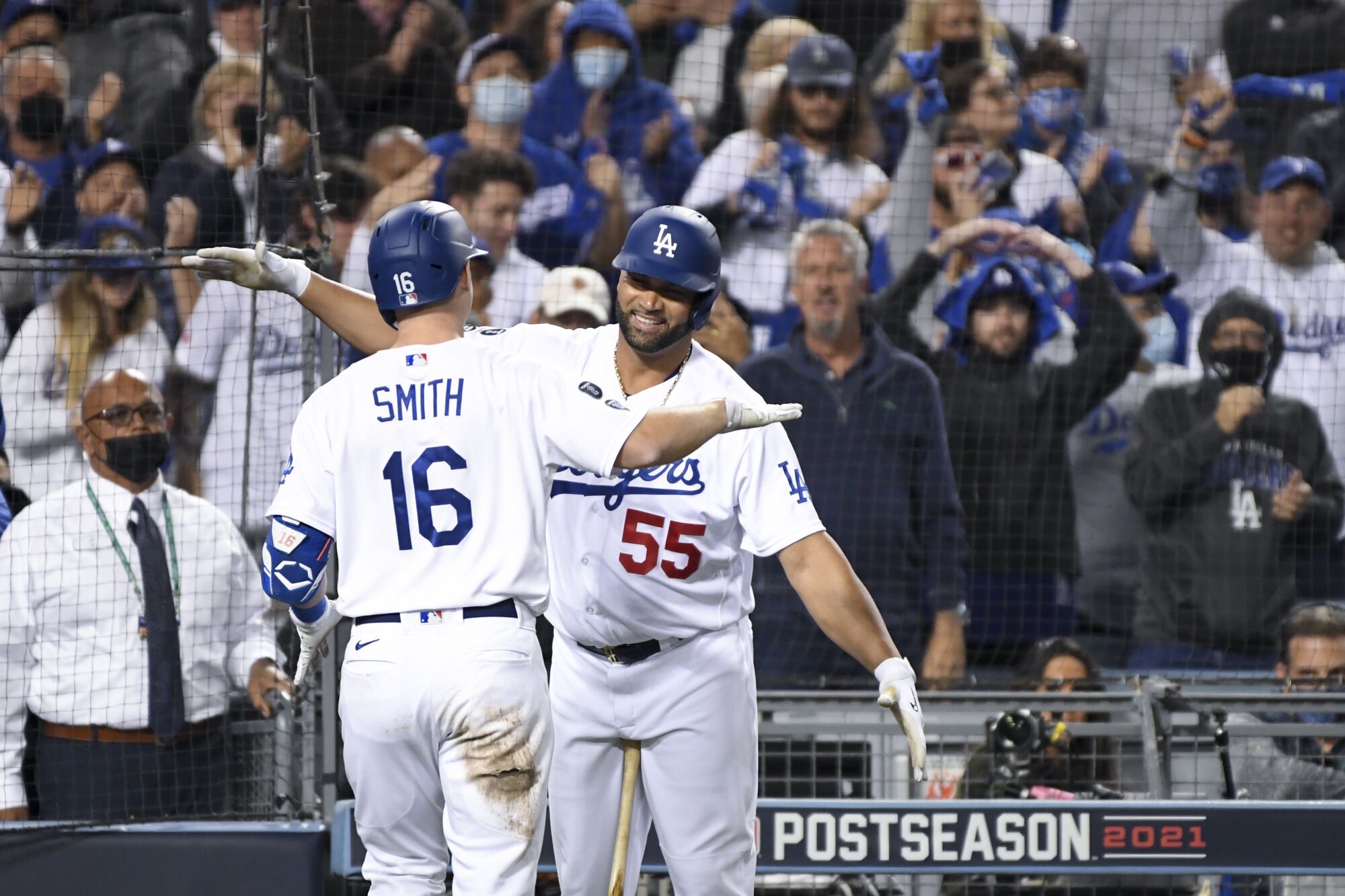 Los Angeles Dodgers' Albert Pujols, right, hugs Will Smith after Smith's two-run home run