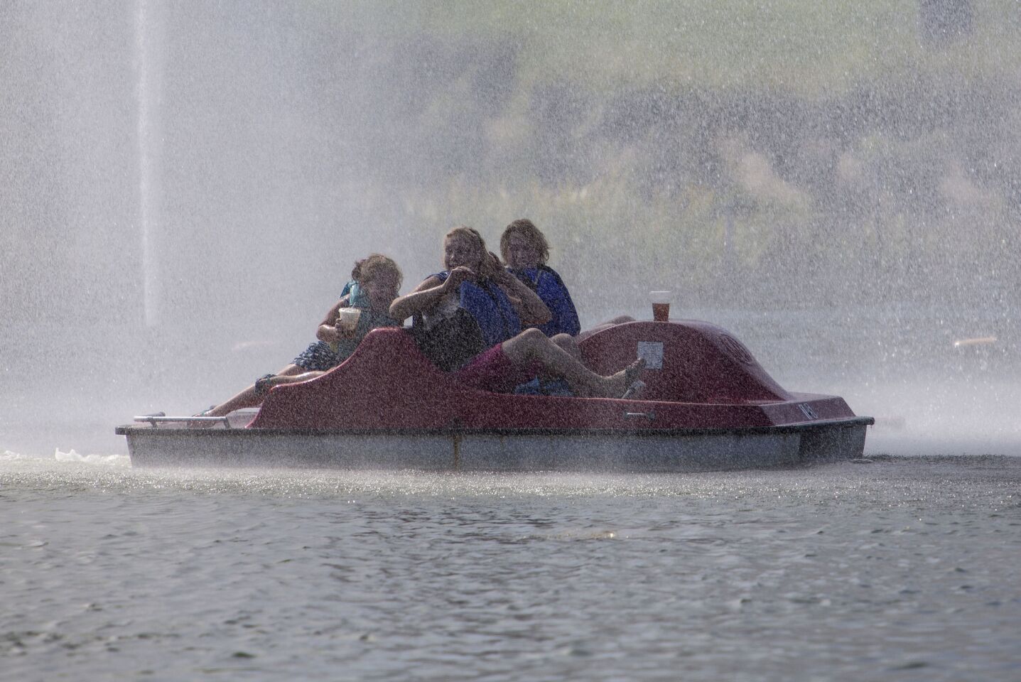 Paddle boaters enjoy the spray from the water fountain on Echo Park Lake.