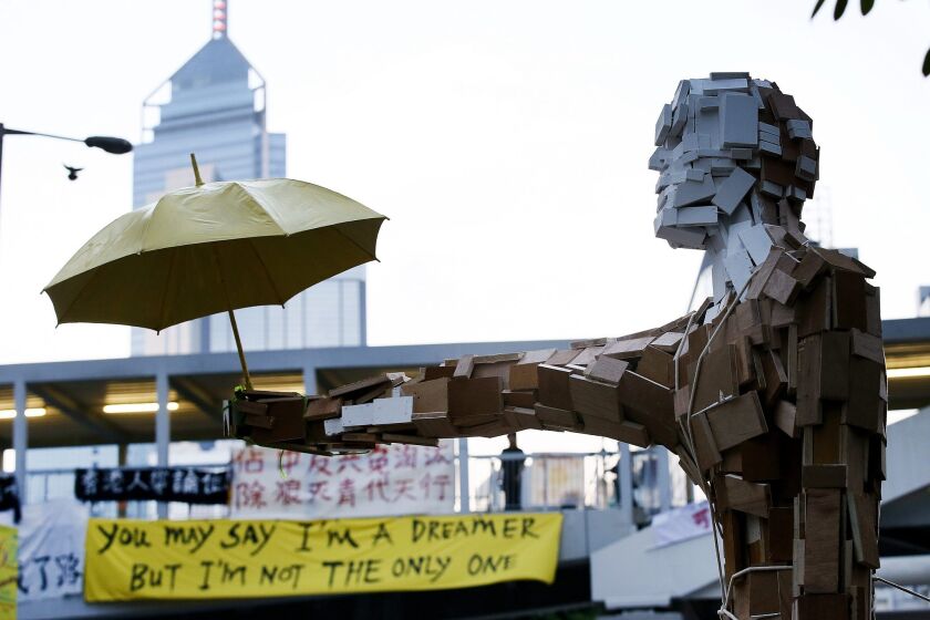 A statue of "Umbrella Man" is placed outside Hong Kong's government offices Monday during ongoing protests in the Admiralty area of Hong Kong.