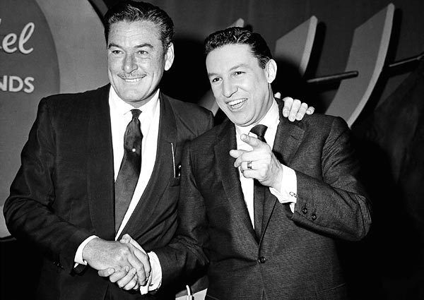 Mike Wallace, right, poses for a photograph with actor Errol Flynn before an episode of NBC's "The Big Surprise," a TV quiz show that Wallace hosted.