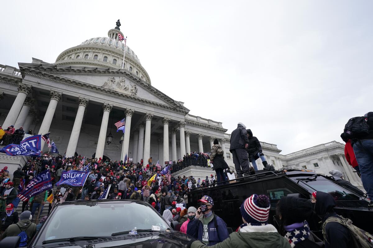 Trump supporters stand on top of a police vehicle Wednesday at the U.S. Capitol.