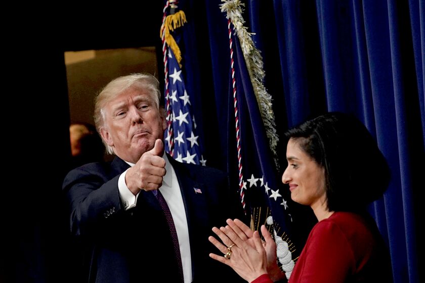WASHINGTON, DC - JANUARY 16: U.S. President Donald Trump (L) acknowledges the audience as Administrator of the Centers for Medicare and Medicaid Services Seema Verma (R) looks on as he stops by a Conversations with the Women of America panel at the South Court Auditorium of Eisenhower Executive Office Building January 18, 2018 in Washington, DC. The three-part panel features ÒAmerican women from various backgrounds and experiences who will speak with high-level women within the Trump Administration, about what has been accomplished to date to advance women at home, and in the workplace.Ó (Photo by Alex Wong/Getty Images)