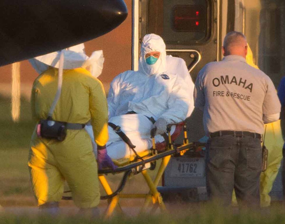 Ashoka Mukpo is placed into an ambulance Oct. 6 after arriving in Omaha, Neb. The American video journalist, who contracted Ebola while working in Liberia, was taken to Nebraska Medical Center for treatment.