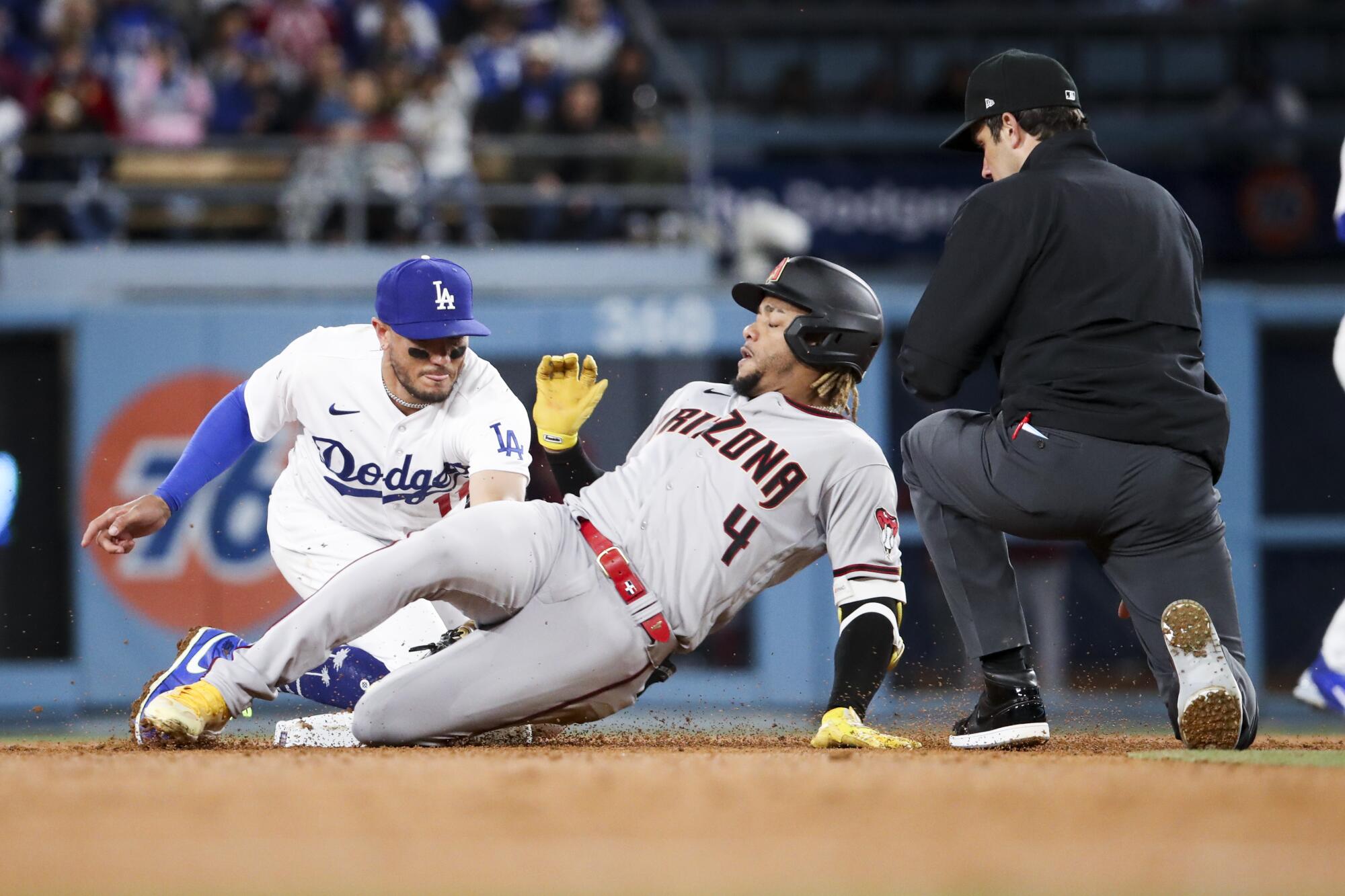 Dodgers shortstop Miguel Rojas, left, tags out Arizona Diamondbacks baserunner Ketel Marte during the sixth inning.