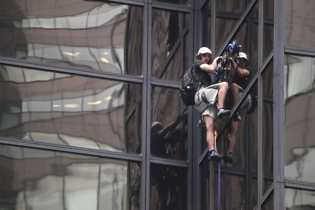 A man scales Trump Tower on Wednesday using suction cups. New York police officers dragged him through a window to safety.