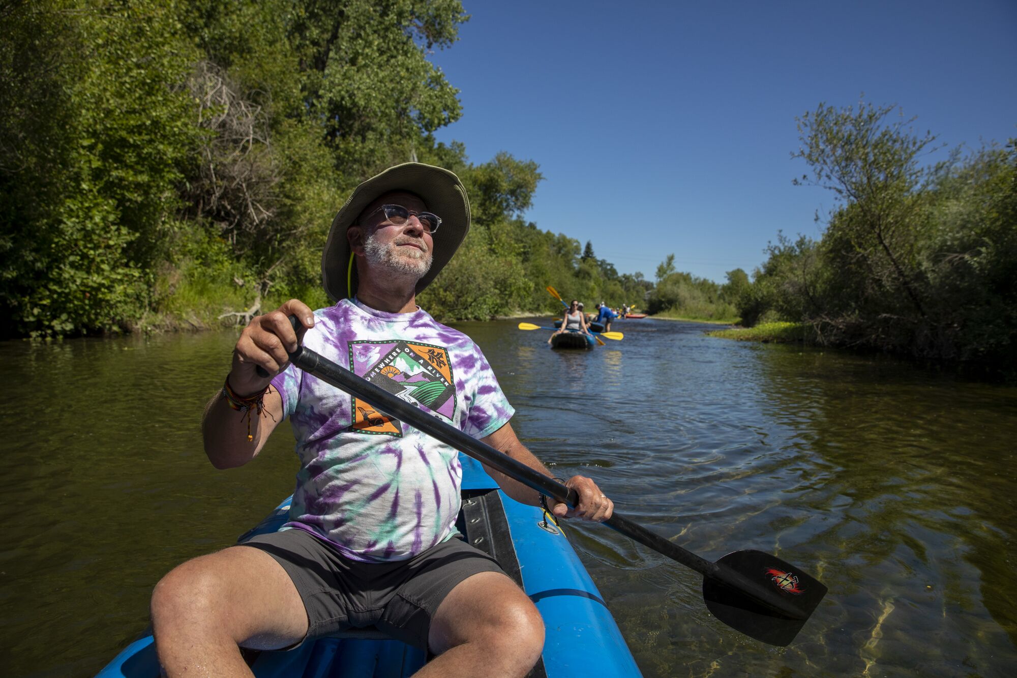 Larry Laba, owner of Russian River Adventures, paddles down the Russian River in Healdsburg, Calif.