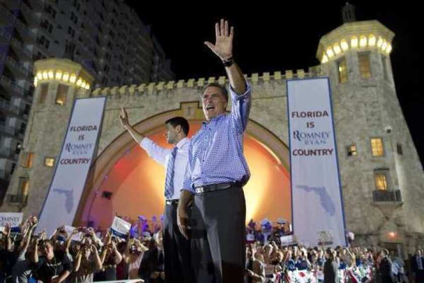Republican presidential candidate Mitt Romney, right, and his running mate, Paul D. Ryan, rally supporters Friday night in Daytona Beach, Fla.
