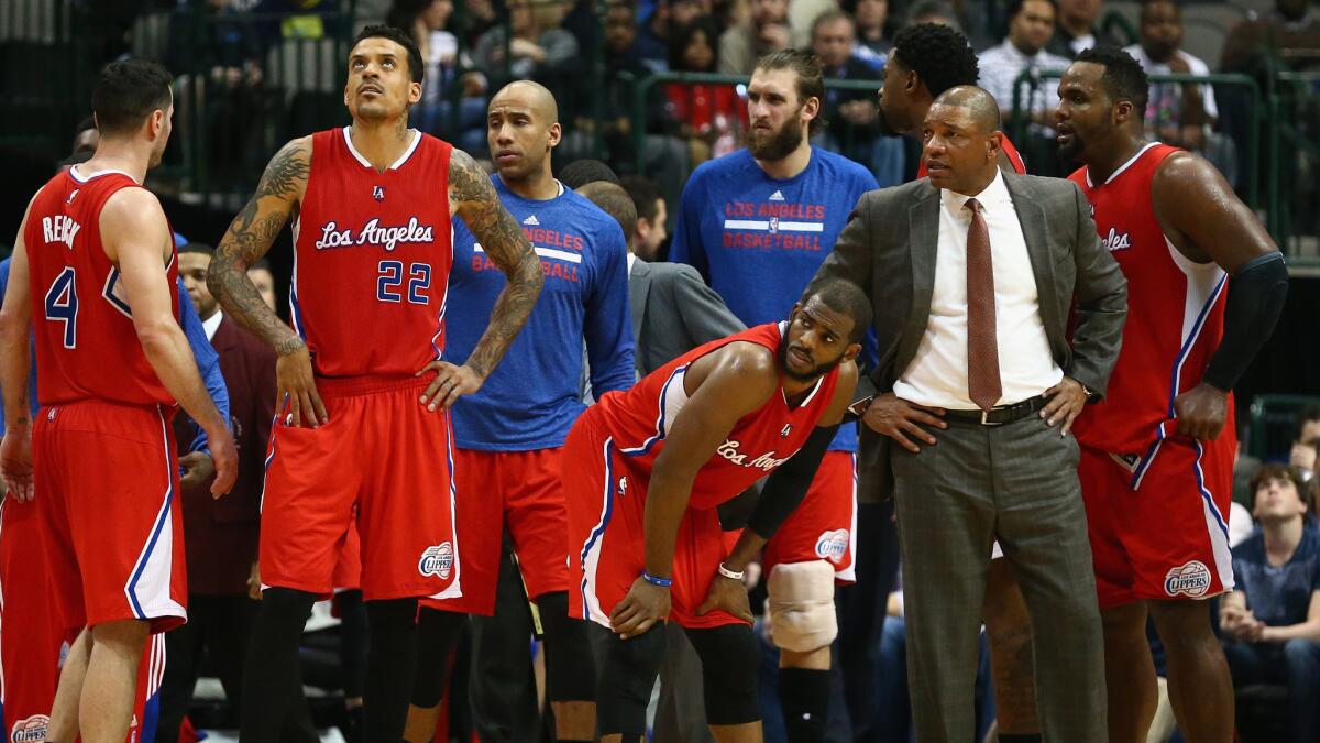 Clippers Coach Doc Rivers, right, stands next to his players during a loss to the Dallas Mavericks on Friday.