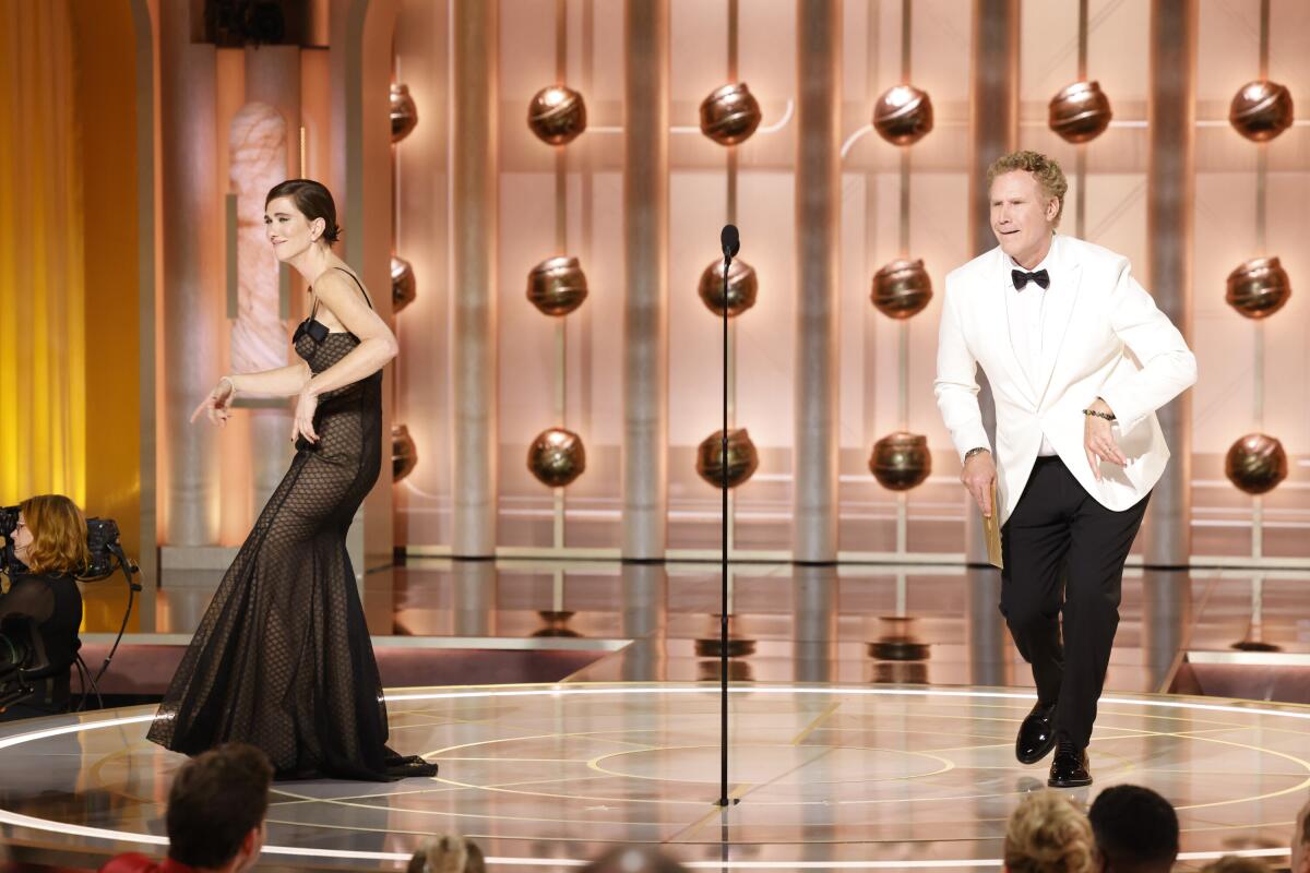 Kristen Wiig and Will Ferrell dance onstage at the Golden Globe Awards.