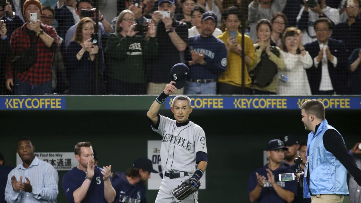 Ichiro Suzuki tips his hat to fans while leaving the field for the last time in his major league career.