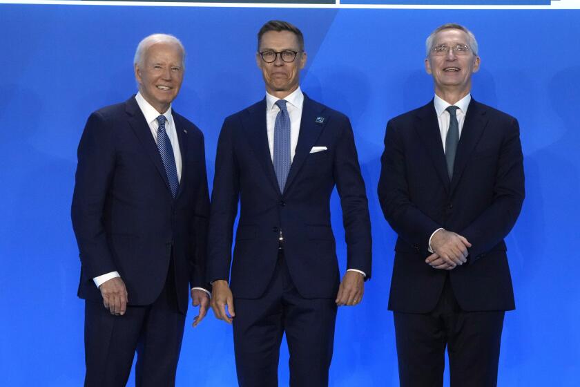 President Joe Biden, left, and NATO Secretary General Jens Stoltenberg, right, greet Alexander Stubb, President of Finland, as they arrive for a welcome ceremony at the NATO summit in Washington, Wednesday, July 10, 2024. (AP Photo/Mark Schiefelbein)