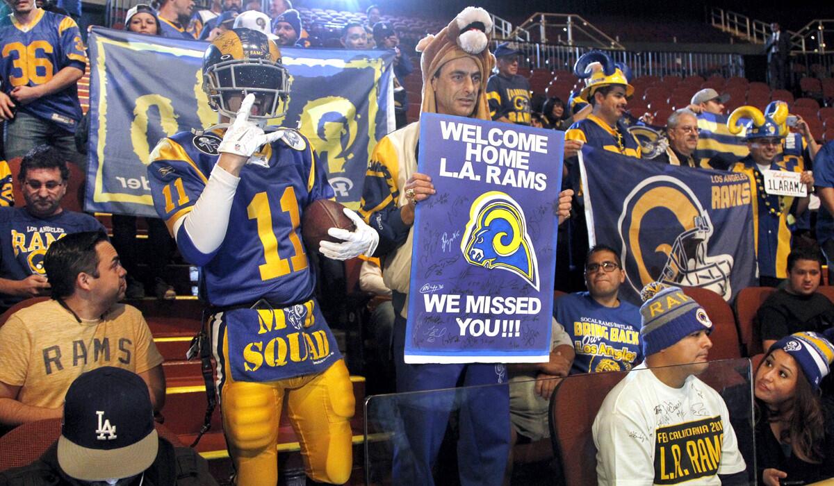 Rams fans cheer for the team at a news conference at the Forum in Inglewood on Friday.