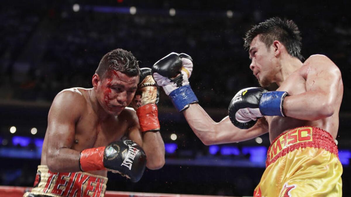 Srisaket Sor Rungvisai, right, punches Roman "Chocolatito" Gonzalez during their WBC super-flyweight championship fight on March 18.