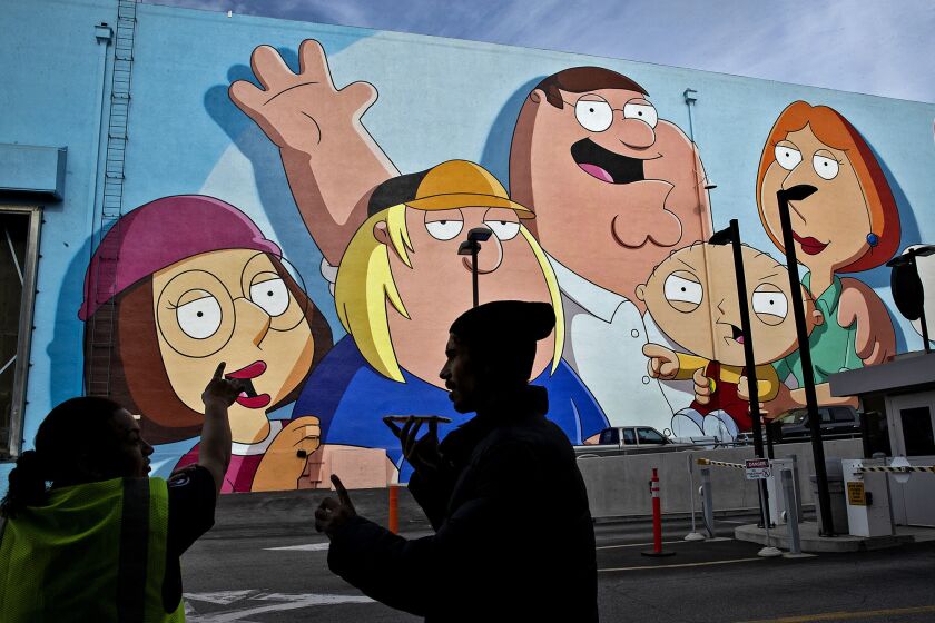 A mural of characters from the animated comedy "Family Guy" decorate the exterior of a sound stage at Fox Studios.