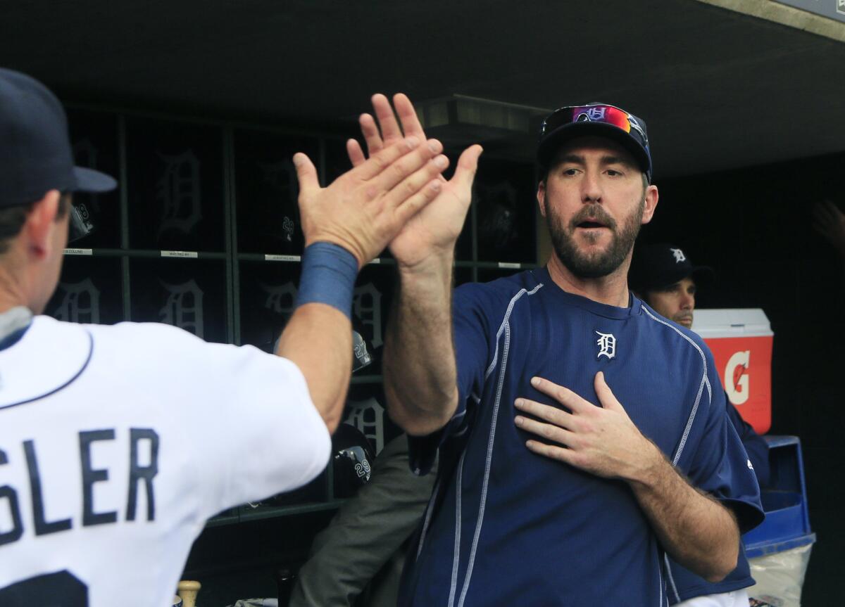 Tigers pitcher Justin Verlander gives a high-five during Tuesday's game against the Cubs. Verlander is expected to make his first start later this week.