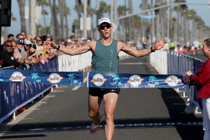 Ben Winfield, 27, of Seattle crosses the finish line first during last September's Surf City Marathon.
