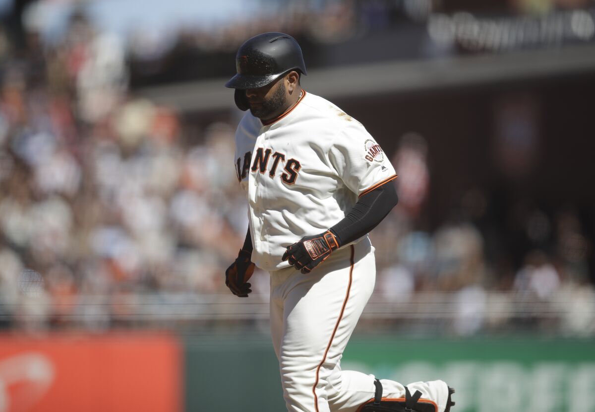 Pablo Sandoval runs off the field after grounding out Sunday.