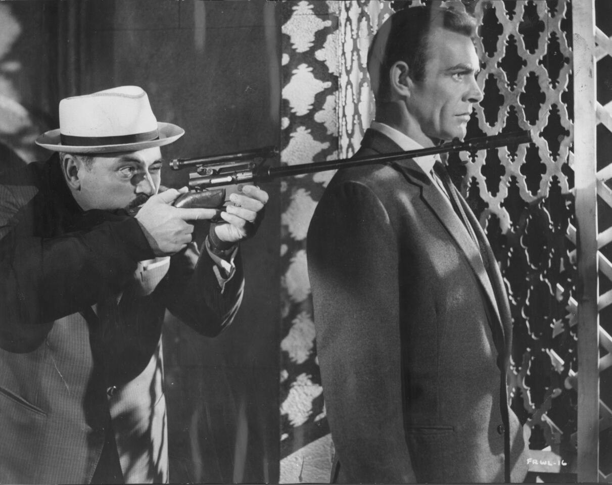 Pedro Armendáriz steadies a rifle on Connery's shoulder in "From Russia With Love."