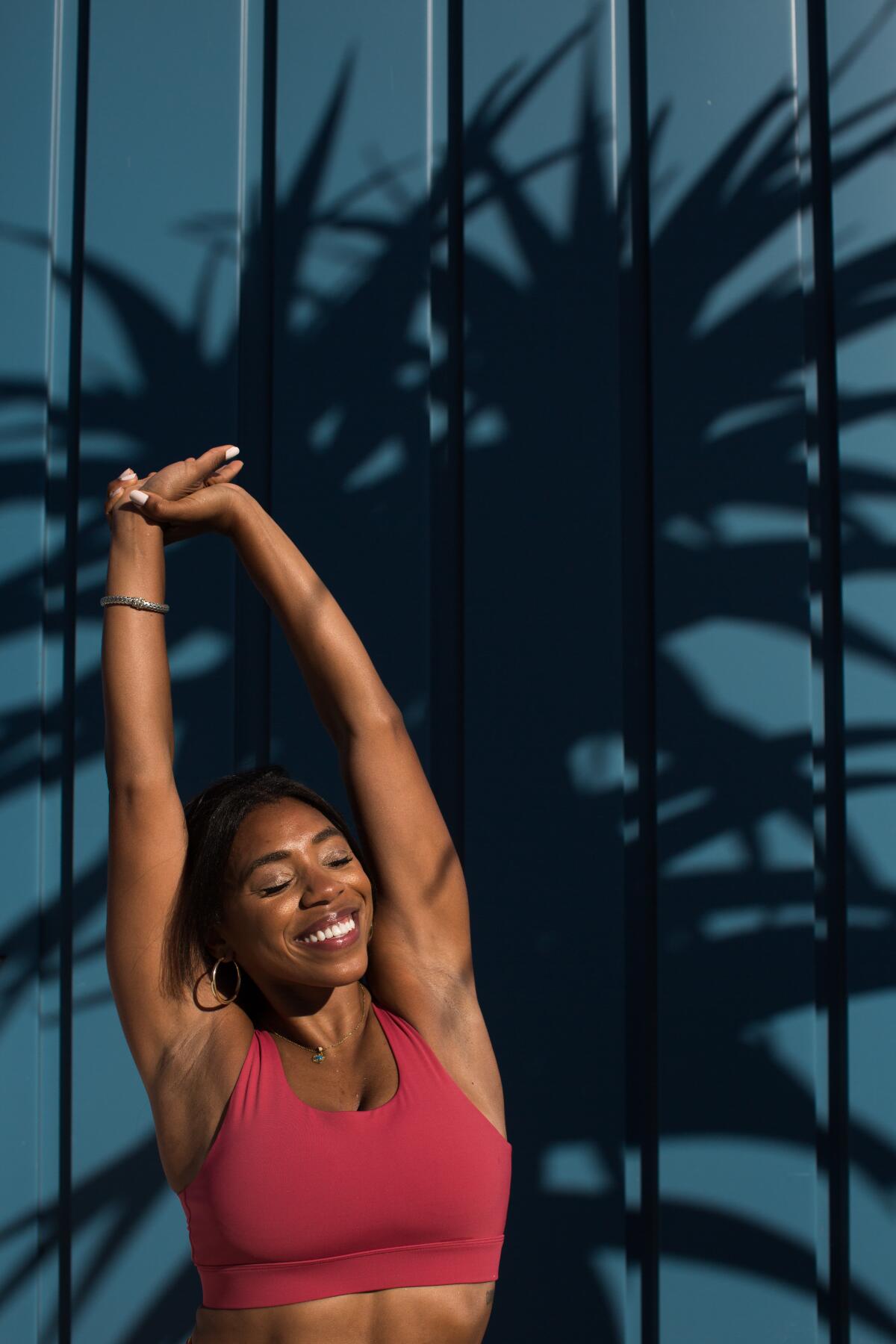 Danielle Richardson, an optometrist turned yoga instructor, stretches in the sun.