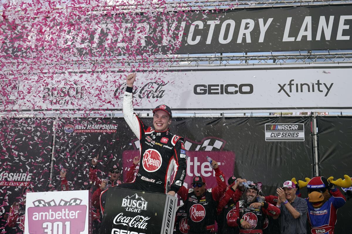 Christopher Bell celebrates after winning a NASCAR Cup Series auto race at the New Hampshire Motor Speedway, Sunday, July 17, 2022, in Loudon, N.H. (AP Photo/Charles Krupa)