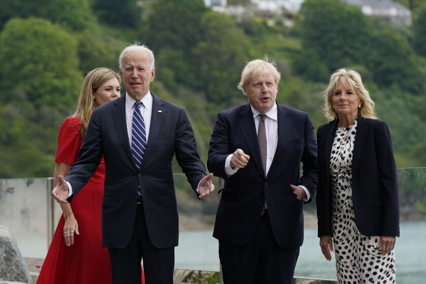 President Joe Biden and first lady Jill Biden are greeted by British Prime Minister Boris Johnson and his wife Carrie Johnson, ahead of the G-7 summit, Thursday, June 10, 2021, in Carbis Bay, England. (AP Photo/Patrick Semansky)