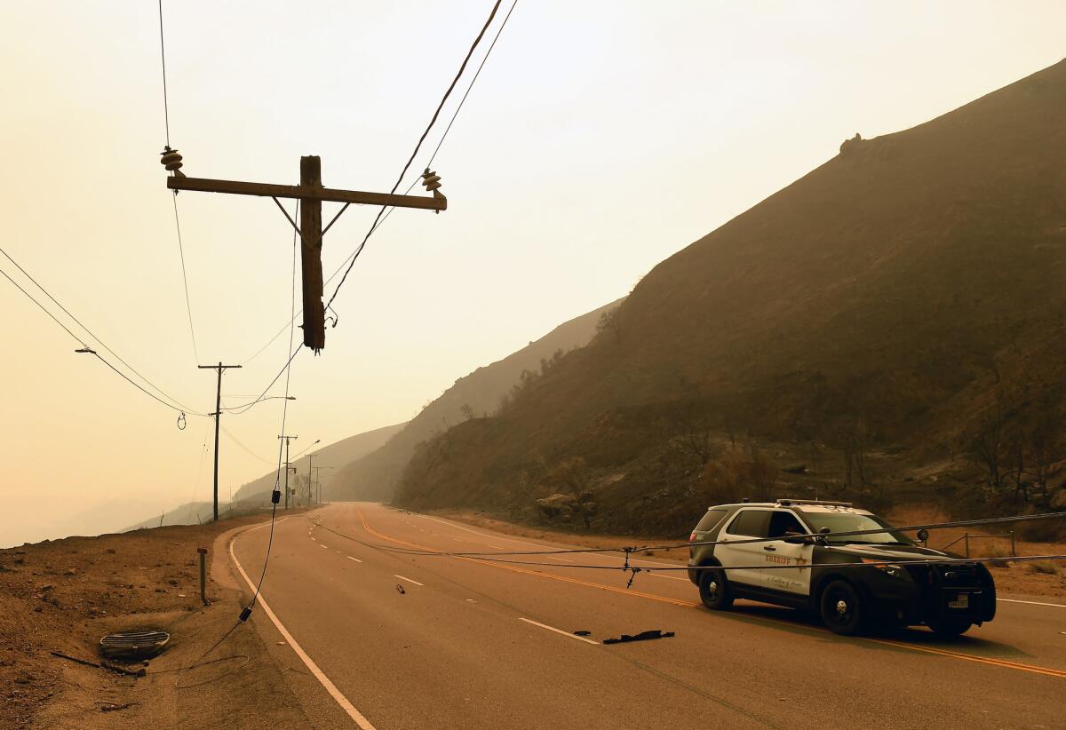 Only the top few feet of a utility pole survived the Woolsey fire as it roared over Kanan Road in Malibu.