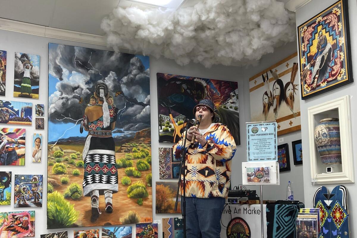 Cody Blackbird performs inside Native Art Market in Scottsdale, Ariz.
