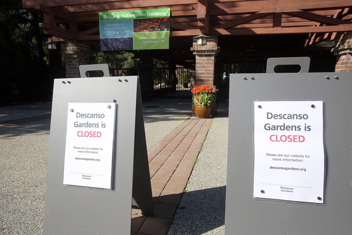 Closed signs at the entrance to Descanso Gardens in La Canada Flintridge last week. An end date for the closure, which is due to coronavirus social-distancing goals, is not known at this time.