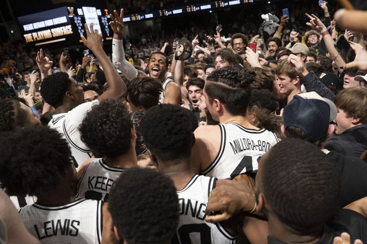 Vanderbilt players and students celebrate the team's win over Tennessee in an NCAA college basketball game Wednesday, Feb. 8, 2023, in Nashville, Tenn. (George Walker IV/The Tennessean via AP)