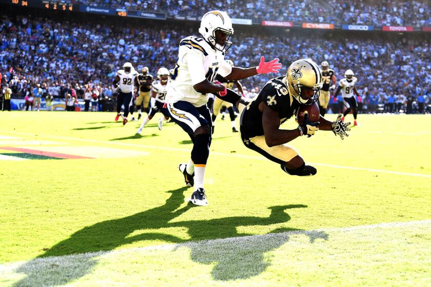 Saints receiver Michael Thomas (13) makes a catch for a touchdown in front of Chargers defensive back Pierre Desir (40) late in the fourth quarter.