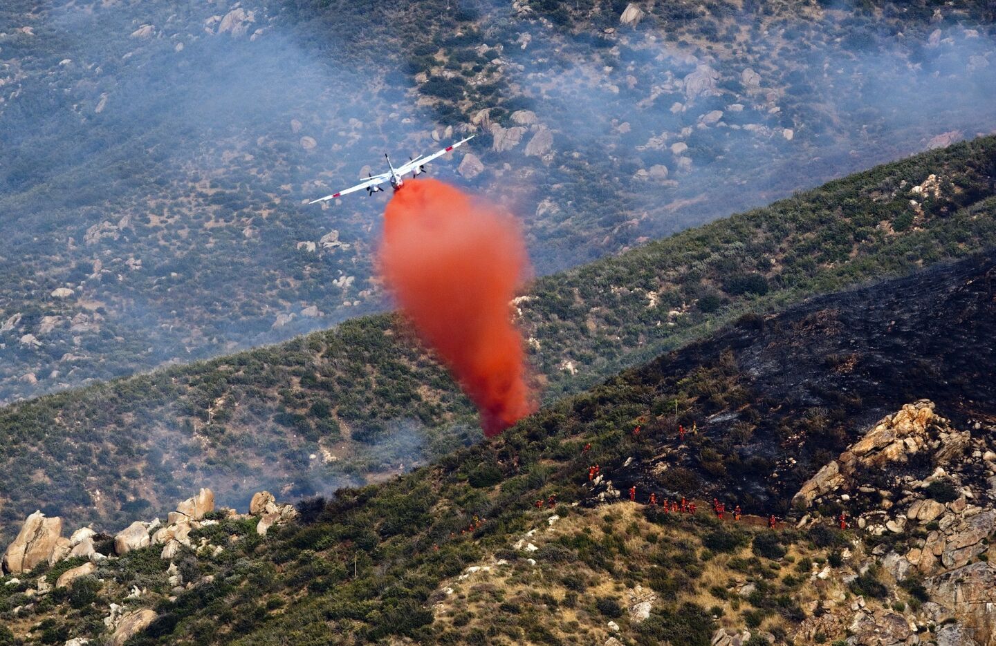 An air tanker drops fire retardant near fire crews in rugged, steep terrain to battle the Gorgonio fire off Highway 243 in Banning. As of 6:30 p.m., the fire was 20% contained at 650 acres. Seven air tankers and two helicopters were on the scene.