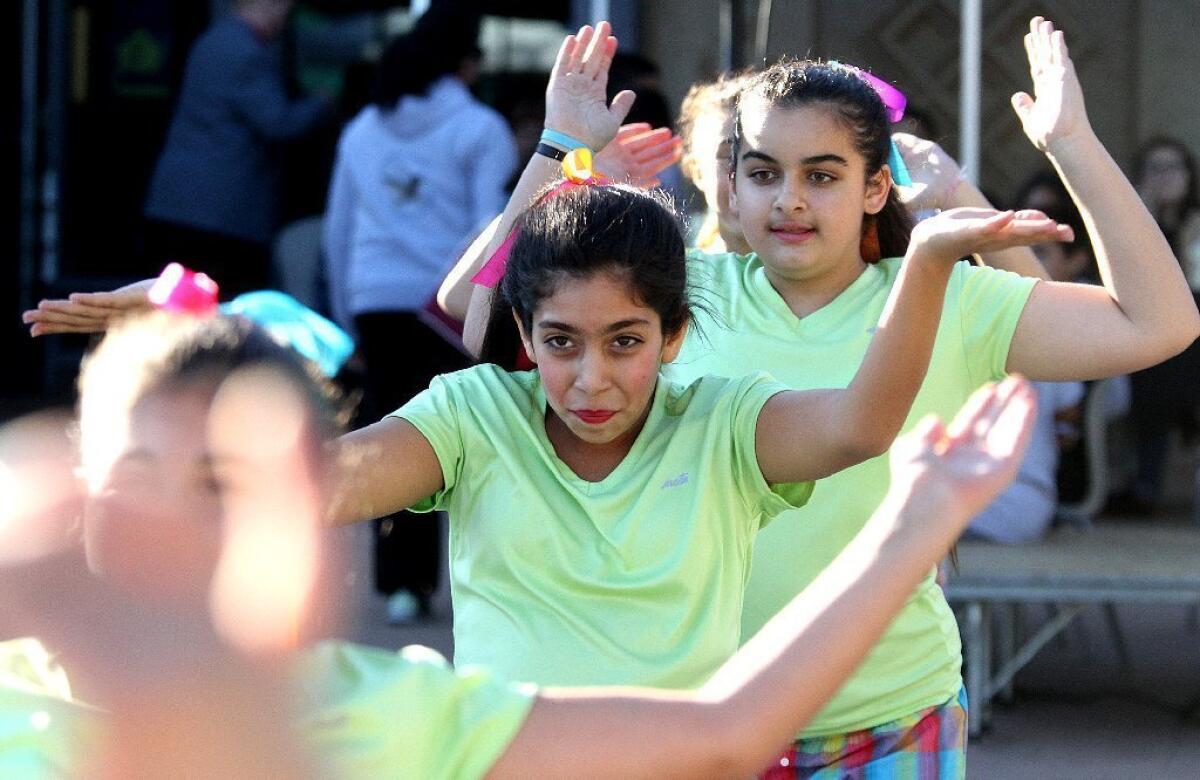 Left to right: Tolou Pharokhipanah, 12, and Christina Baltayan, 13, of Toll Middle School dances with the Toll Elite Dance Group during the "30th Annual National Night Out," at the Pacific Community Center in Glendale on Tuesday, August 6, 2013.