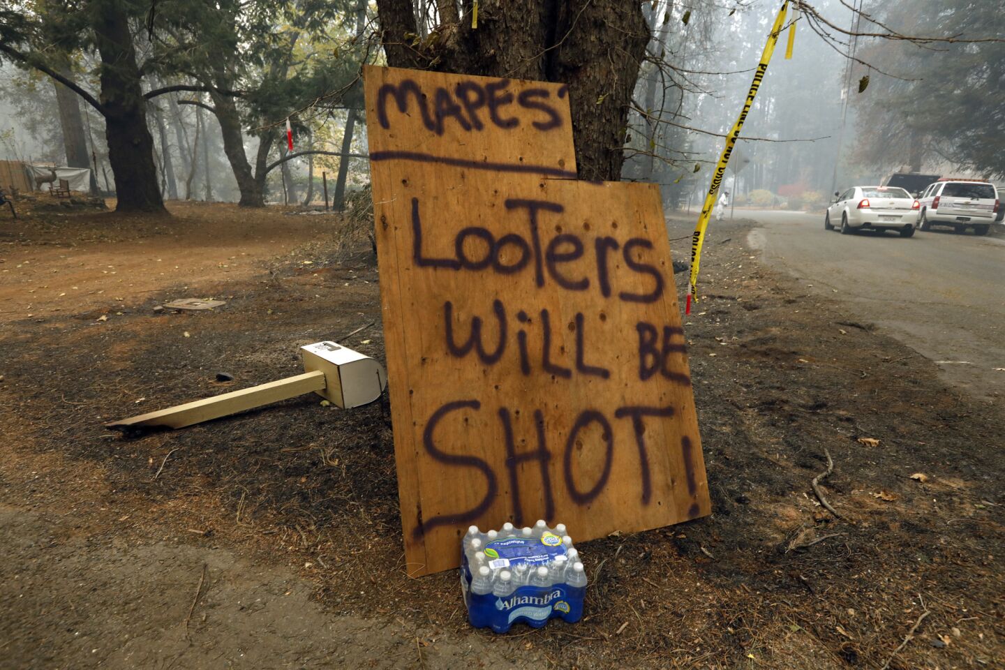 A sign in Paradise offers a warning for would-be looters.