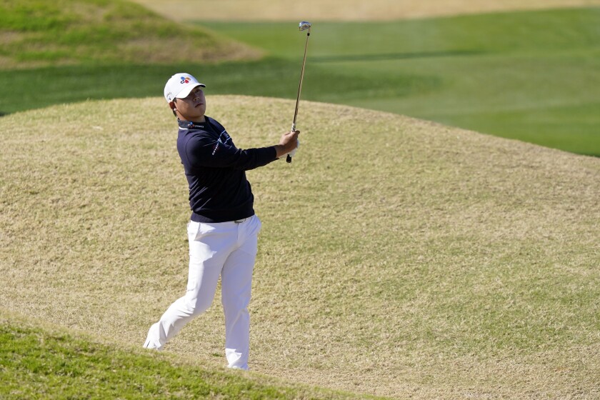 Si Woo Kim hits from the rough on the fifth hole during the final round of The American Express tournament.