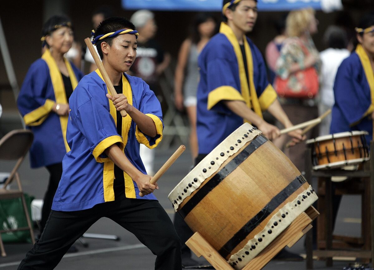 Laura Yamaguchi strikes her taiko during a performance at the Bon Odori, or Gathering of Joy, at the Buddhist Temple of San Diego in Grant Hill Saturday.
