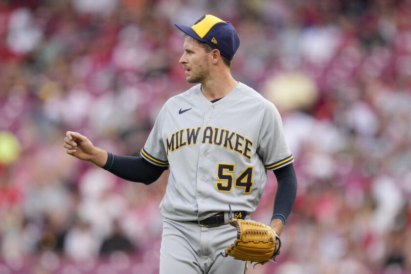 FILE - Milwaukee Brewers relief pitcher Jake Cousins looks on during a baseball game against the Cincinnati Reds in Cincinnati, June 3, 2023. Cousins was acquired by the New York Yankees from the Chicago White Sox on Sunday, March 31, 2024, for cash. (AP Photo/Jeff Dean, File)