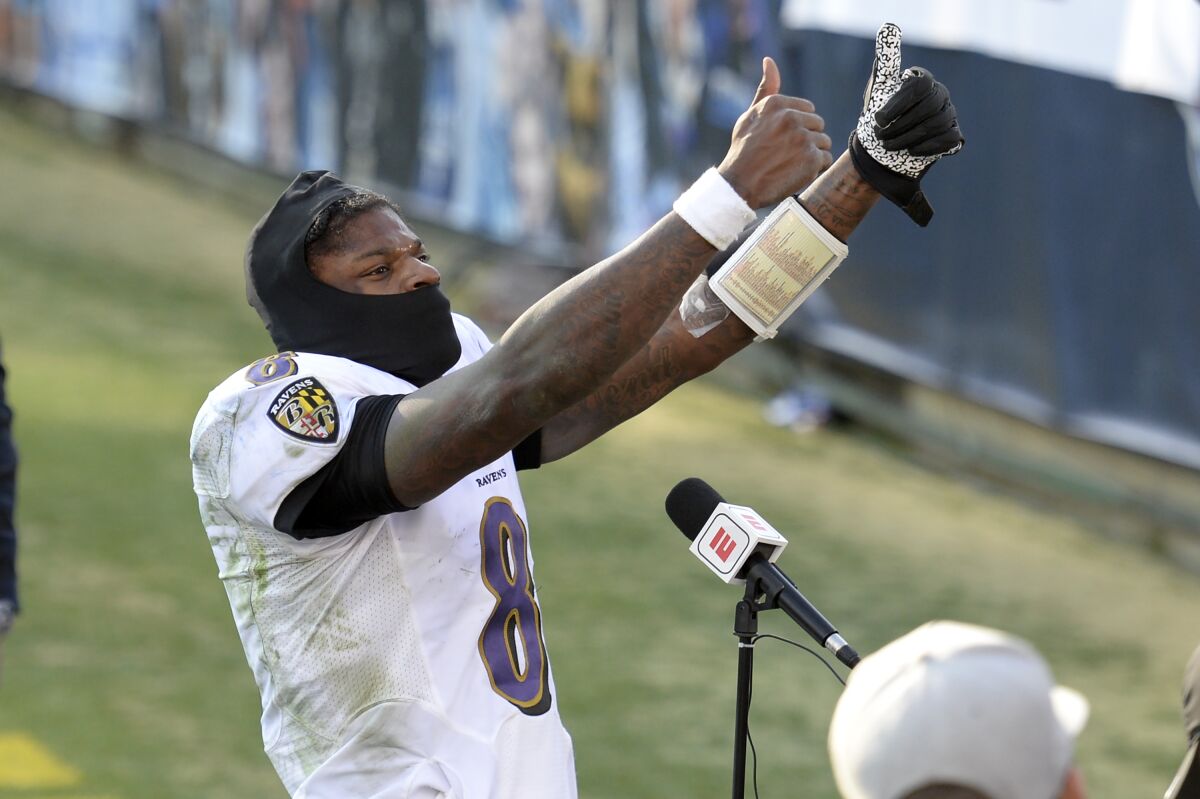 Baltimore Ravens quarterback Lamar Jackson celebrates after the Ravens beat the Tennessee Titans in an NFL wild-card playoff football game Sunday, Jan. 10, 2021, in Nashville, Tenn. (AP Photo/Mark Zaleski)