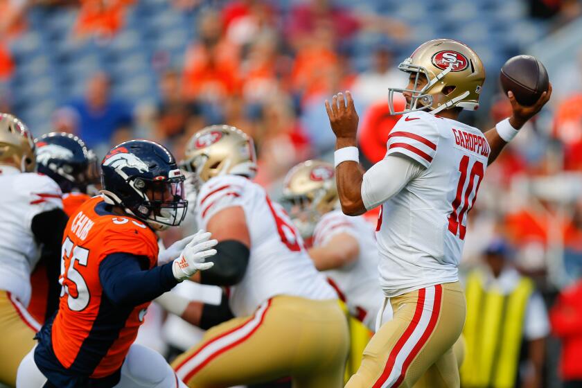 San Francisco 49ers quarterback Jimmy Garoppolo throws an interception under pressure from Broncos linebacker Bradley Chubb duringa preseason game Aug. 19 in Denver.