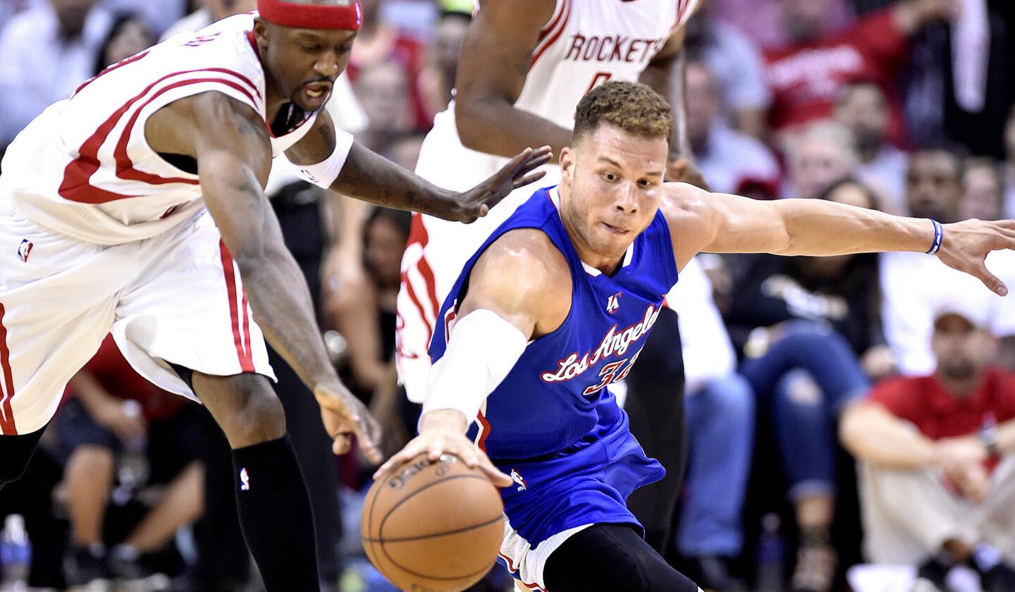 Clippers power forward Blake Griffin dives to the court for a loose ball ahead of Rockets shooting guard Jason Terry. The Clippers won Game 1, 117-101.