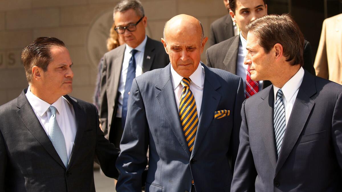 Former L.A. County Sheriff Lee Baca, center, departs the Los Angeles Federal Courthouse after his sentencing.
