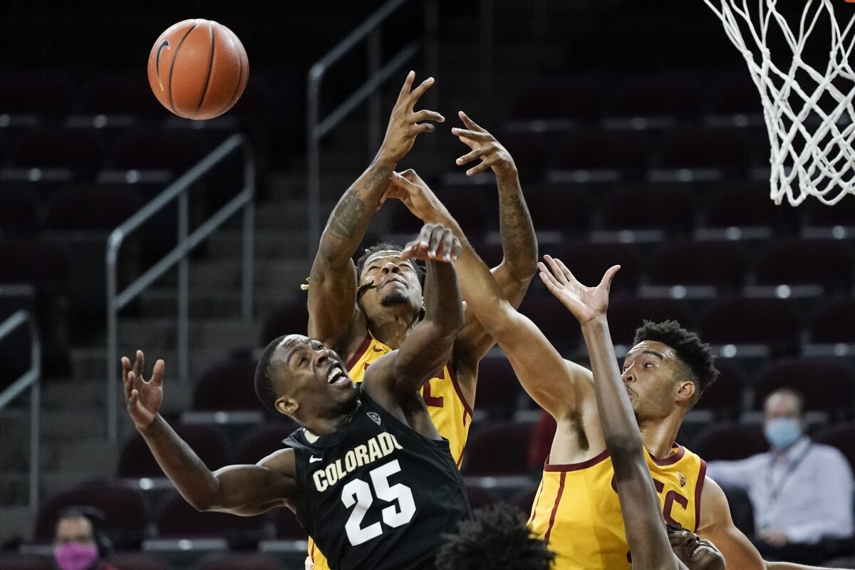 Colorado's McKinley Wright IV, bottom left, battles USC's Isaiah Mobley, right, and Isaiah White.