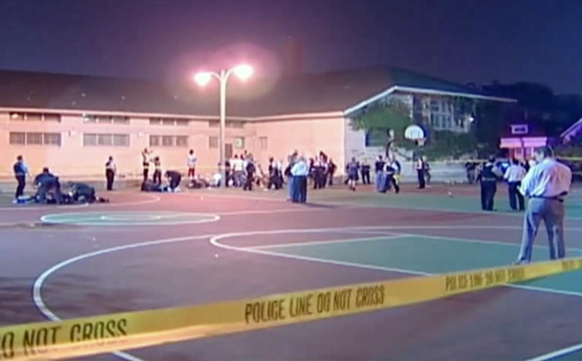 A still frame from a video shows the scene where a number of people, including a 3-year-old child, were shot in a city park in Chicago.