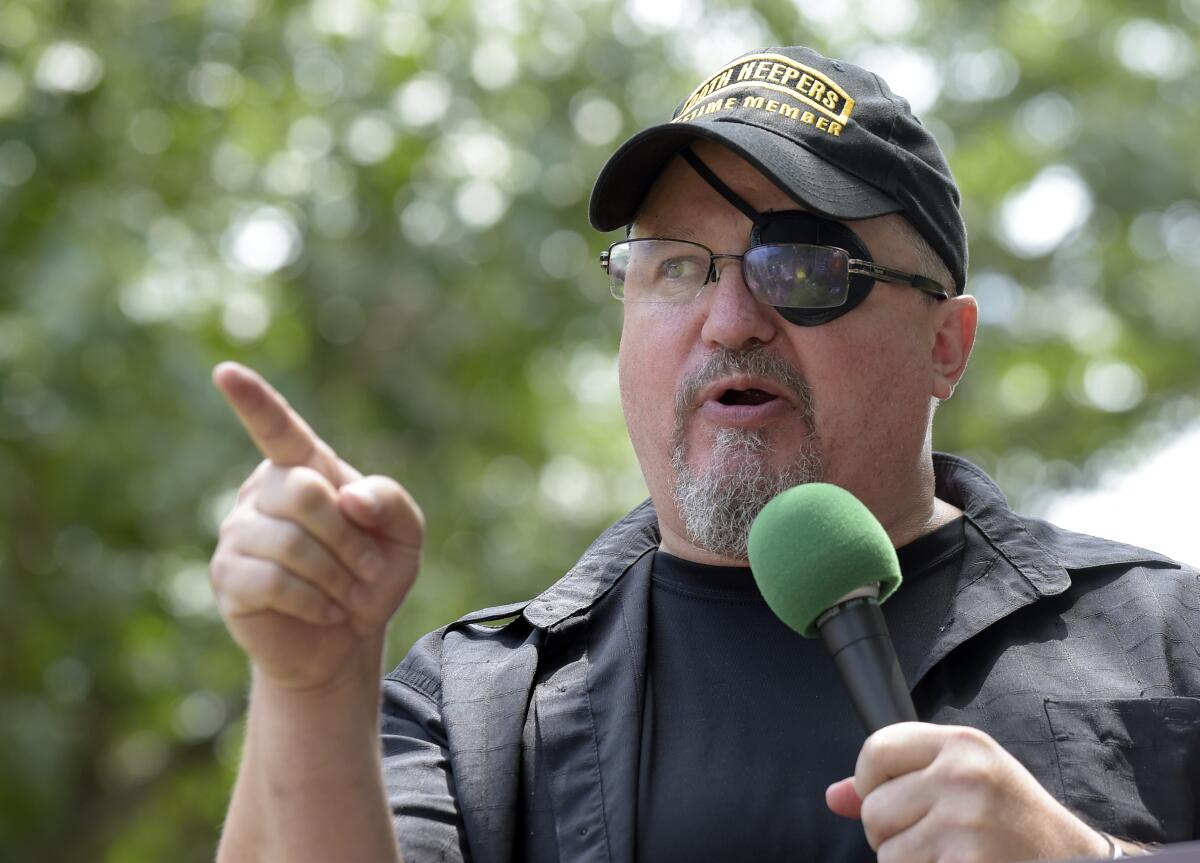 Oath Keepers founder Stewart Rhodes speaking into a microphone outside