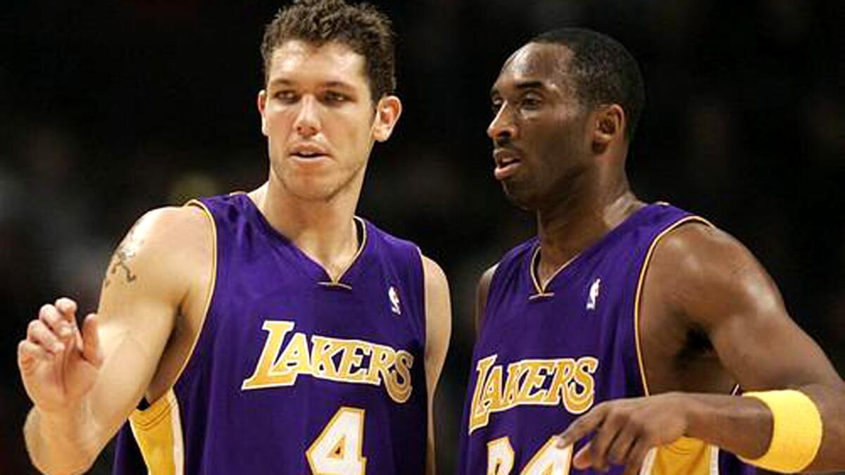 Luke Walton, left, speaks with Kobe Bryant during a game on Dec. 19, 2006.