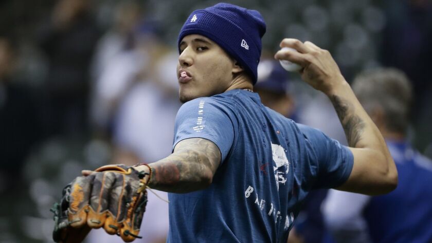 The Dodgers' Manny Machado warms up before Game 6 of the National League Championship Series baseball game against the Milwaukee Brewers Friday, Oct. 19, 2018, in Milwaukee.
