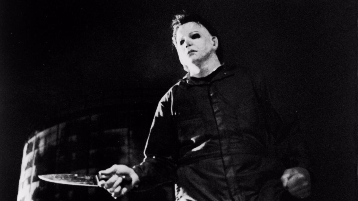 Actor Tony Moran, as masked killer Michael Myers, wields a knife in a still from "Halloween."