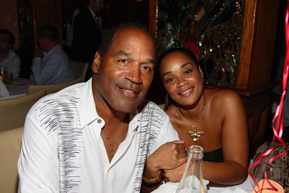 O.J. Simpson and daughter Arnelle at a restaurant in Miami Beach in 2007. (Alexander Tamargo / Getty Images)