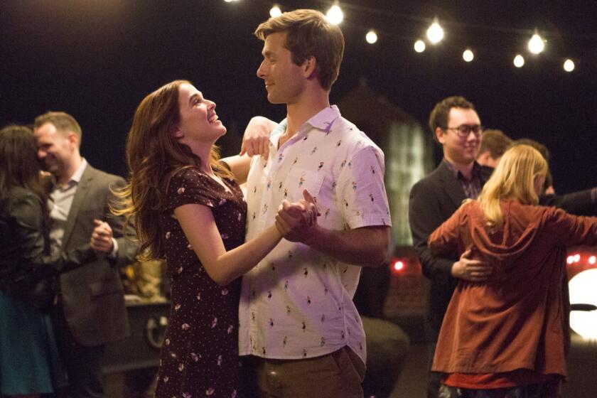 This image released by Netflix shows Zoey Deutch, left, and Glen Powell in a scene from "Set It Up," premiering June 15 on Netflix. (KC Baily/Netflix via AP)